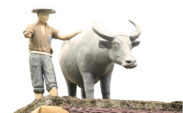 The Tamaraw Monument — a campus landmark depicting a farmer standing beside a carabao